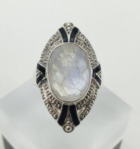 Silver ring with oval moonstone and details.