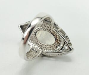 Silver ring with intricate geometric design.