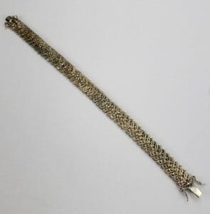 Gold chain bracelet on white background.