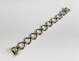 Silver chain bracelet on white background.