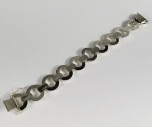 Silver chain link bracelet on white background.