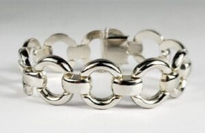 Silver link chain bracelet on white background.