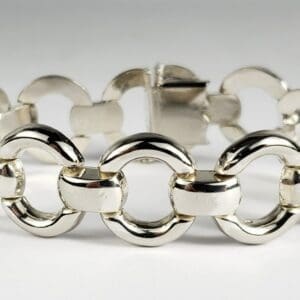 Silver link chain bracelet on white background.