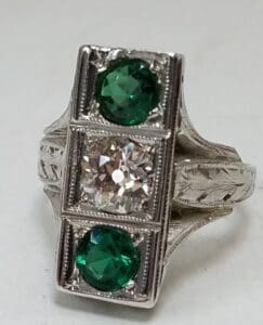 Silver ring with green and clear stones.