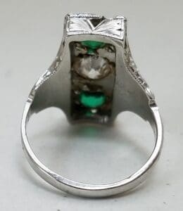 Silver ring with green and clear stones.