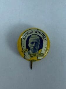 Yellow "Arthur Whitney for Governor" campaign button.