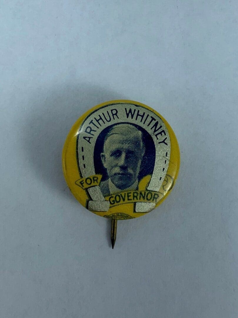 Yellow "Arthur Whitney for Governor" campaign button.