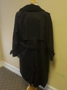 Black trench coat on a mannequin.
