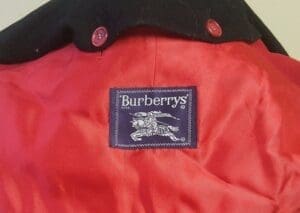 Burberry label on red fabric coat.