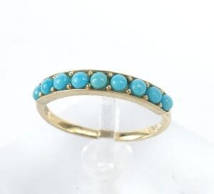 Gold ring with turquoise gemstone accents.