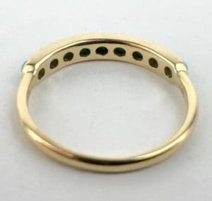 Gold ring with turquoise inlaid stones.