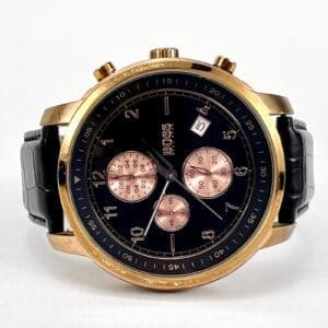 Gold wristwatch with black and gold face.