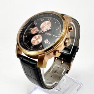 Gold wristwatch with black leather strap.