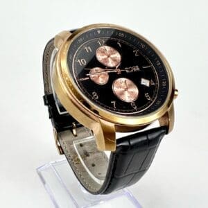 Gold wristwatch with black leather strap.