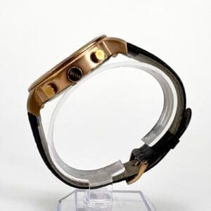 Gold watch with black leather strap.