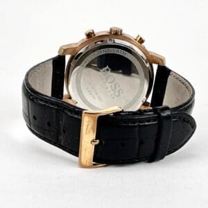 Black leather wristwatch with gold buckle.