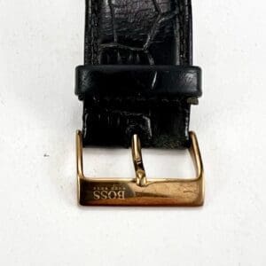 Black leather belt with gold buckle.