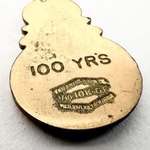 Gold pendant with "100 YRS" inscription.