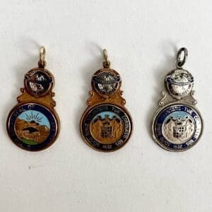 Three decorative medallions with intricate designs.