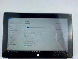 Tablet with cracked screen displaying storage settings.