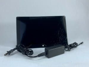 Broken screen tablet with charger cable.