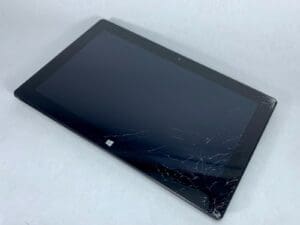 Cracked screen tablet on white background.