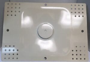 Metallic plate with perforated edges and center.