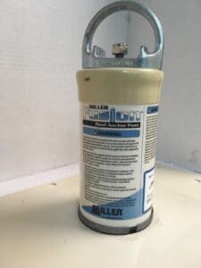 Roof anchor post with safety instructions visible.