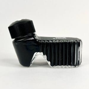 Unique black ink bottle, angled design.