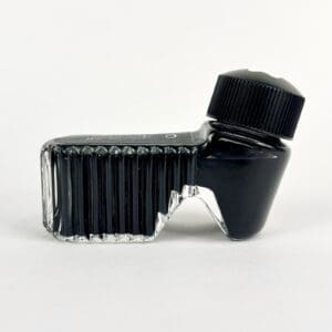 Unique black ink bottle with angled design.