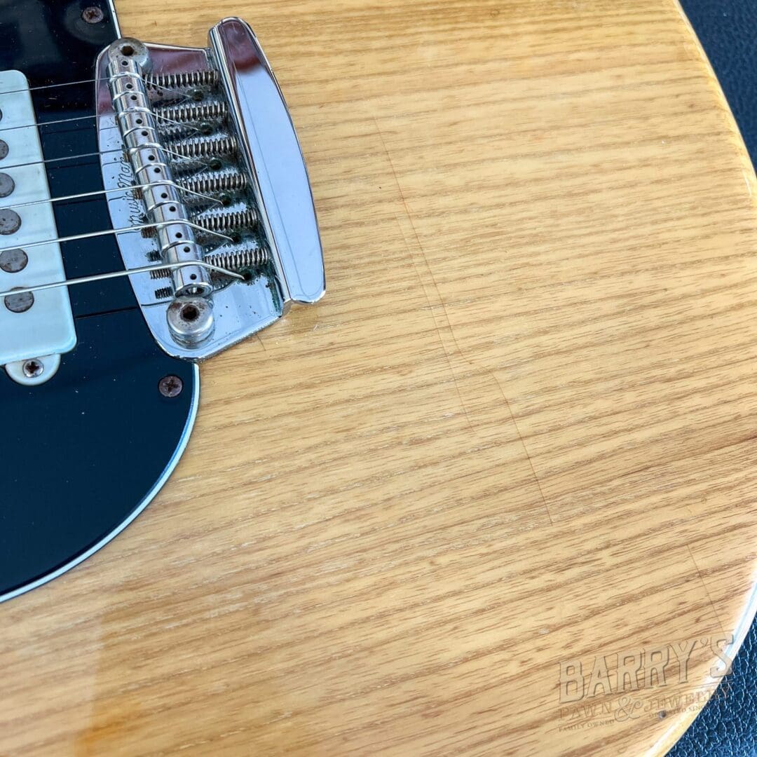 Electric guitar bridge and strings close-up.