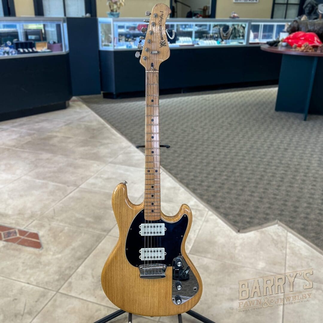 Electric guitar displayed on a stand indoors.