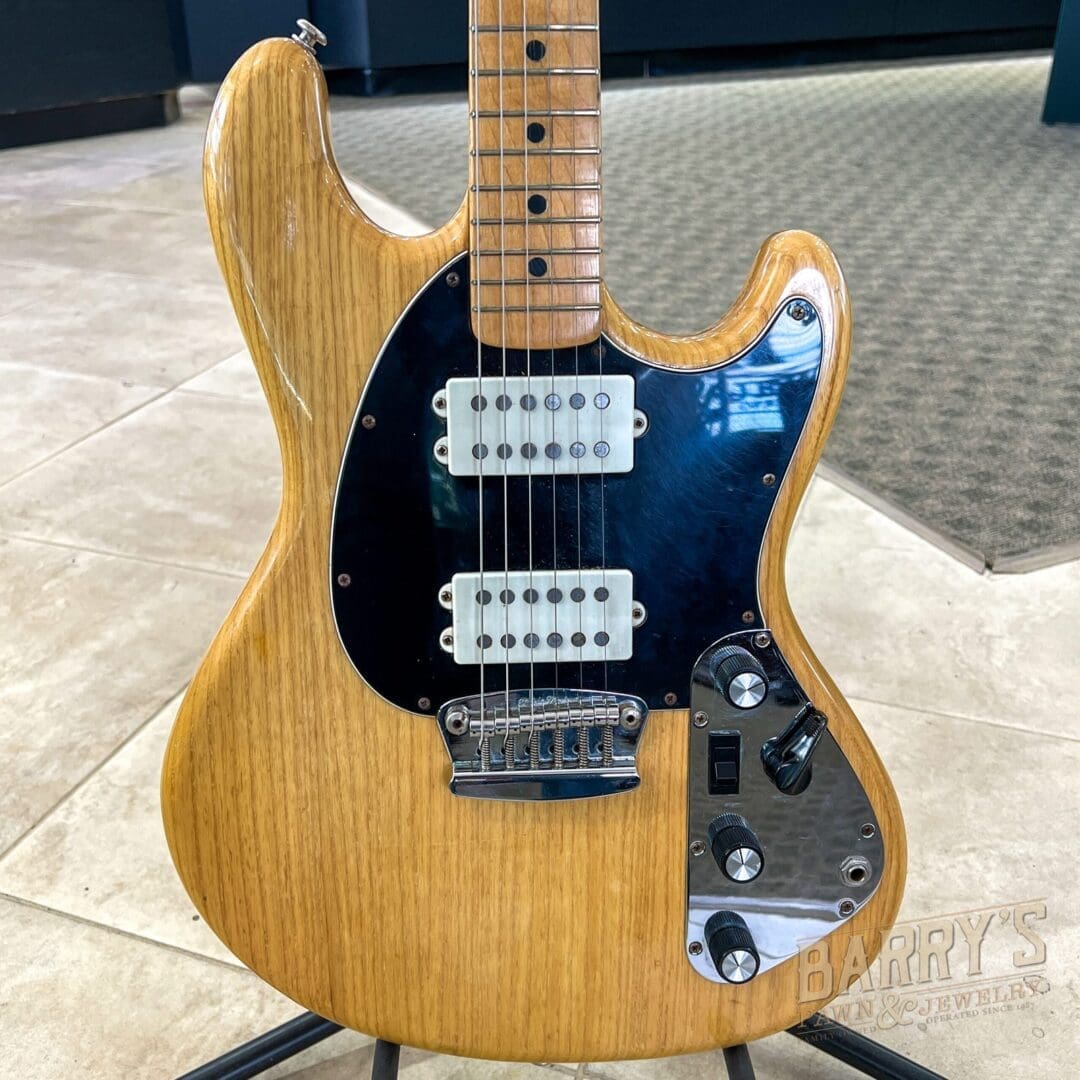 Vintage electric guitar with wooden finish.