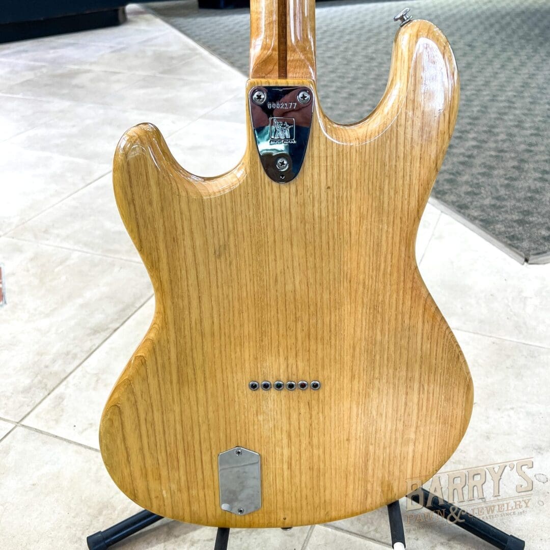 Wooden electric guitar body on stand.