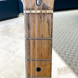 Wooden guitar neck with strings and frets.