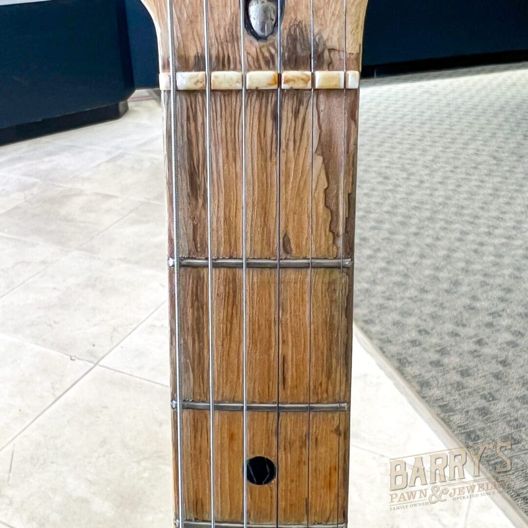 Wooden guitar neck with strings and frets.