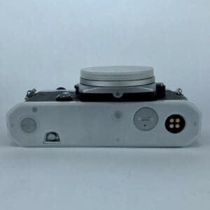 Vintage camera bottom view, lens cap on.