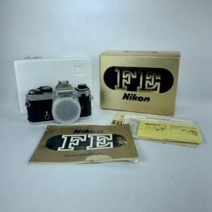 Nikon FE camera with box and manuals.