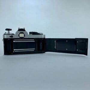 Open vintage camera showing film compartment.