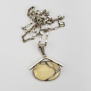 Silver chain with oval stone pendant.