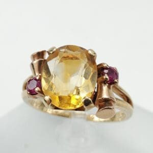 Gold ring with yellow and red gemstones.