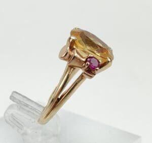 Gold ring with amber and pink stones.