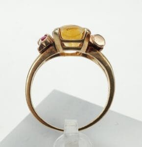 Gold ring with yellow and red gemstones.