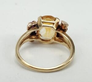Gold ring with gemstone setting, rear view.