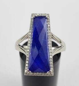 Silver ring with large blue gemstone.