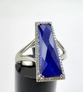 Silver ring with large blue gemstone.