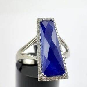 Silver ring with large blue gemstone.