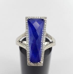 Silver ring with large blue gemstone.