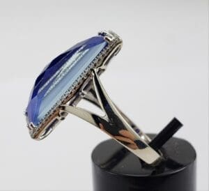 Silver ring with large blue gemstone.