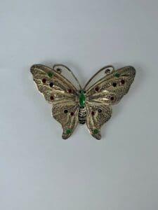 Ornate butterfly brooch with colorful gemstones.